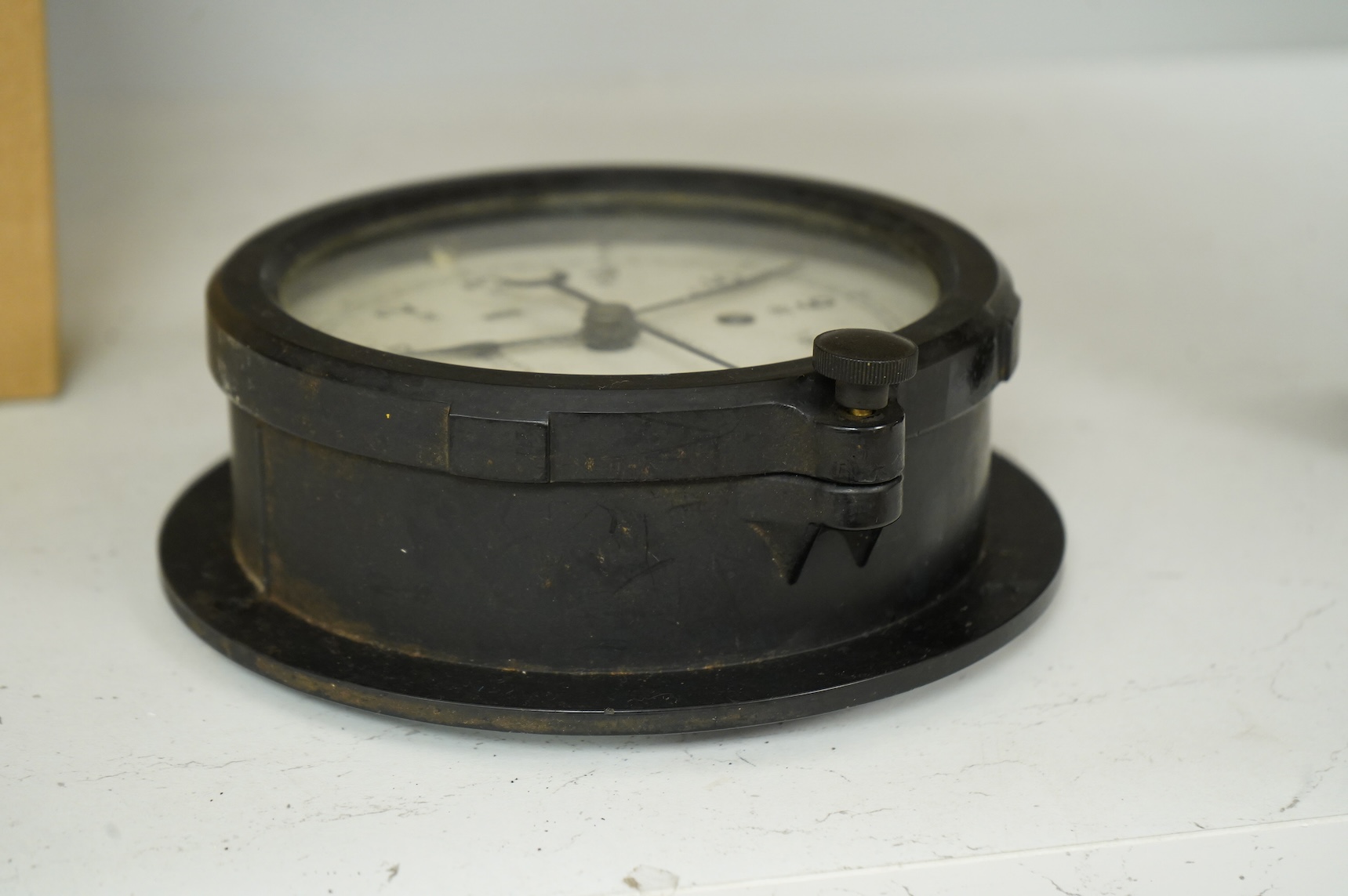A U.S. Government Chelsea Clock Co., Boston, ship’s bulkhead clock in Bakelite case, diameter 17cm with key